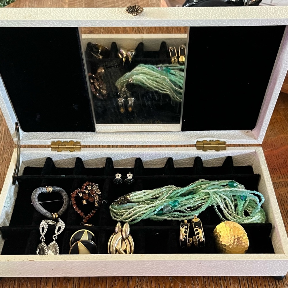 Vintage leather covered footed jewelry box filled with jewelry
